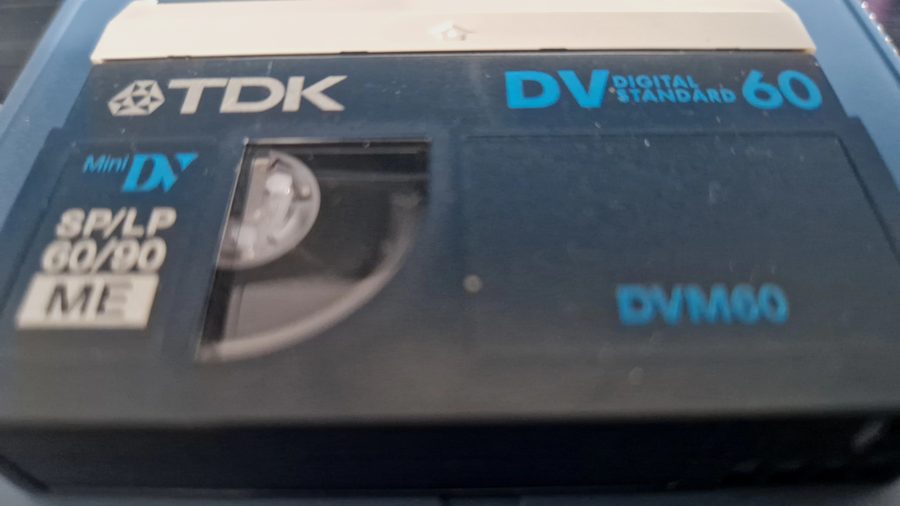 Close-up of a TDK Mini DV tape, a common digital camcorder tape format